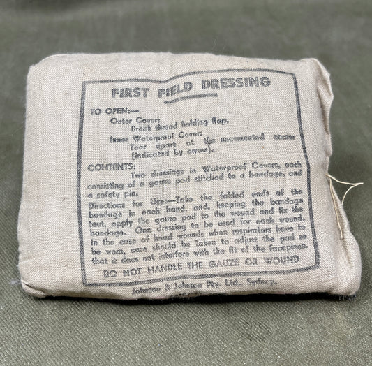 First field dressing package with text on a gray background