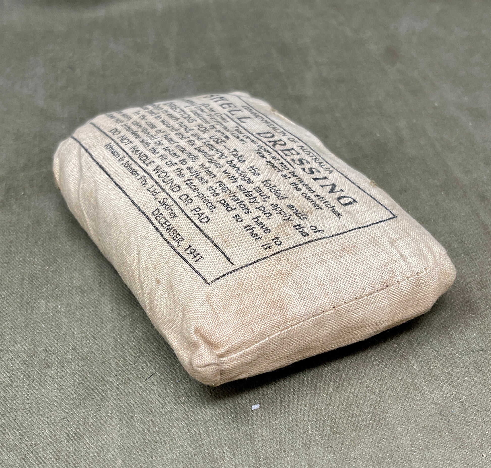 Rectangular bandage with text on a gray surface