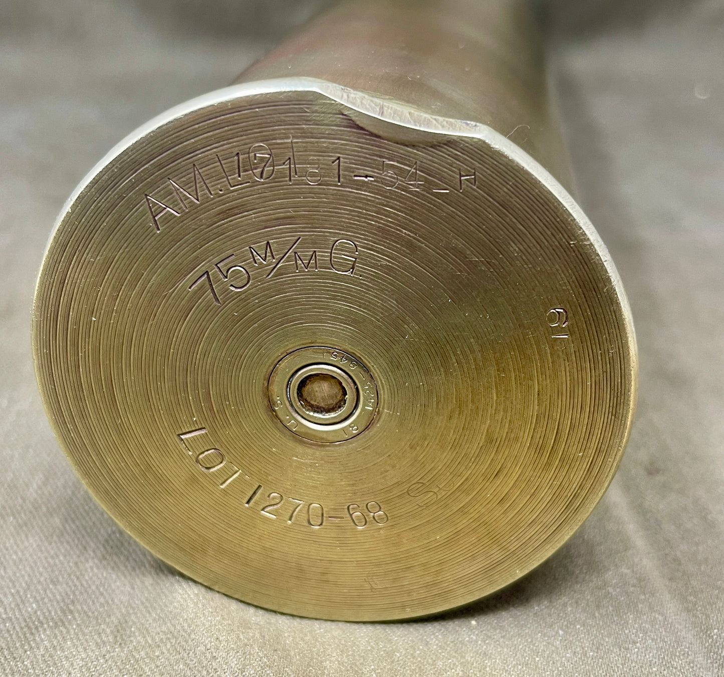 Close-up of a brass artillery shell on a gray background