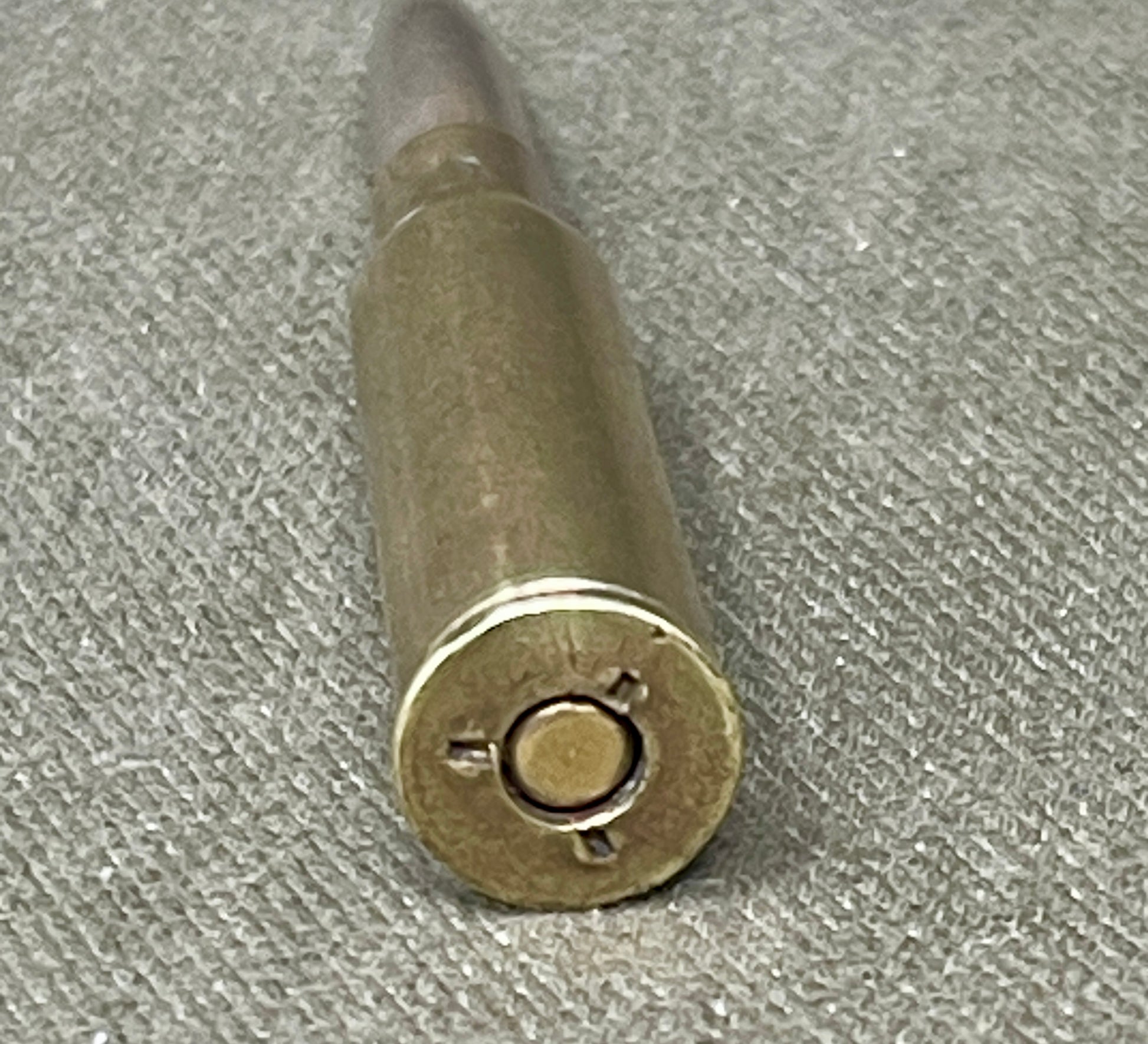 Bullet casing on a textured gray surface
