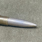 Metallic bullet on a textured surface