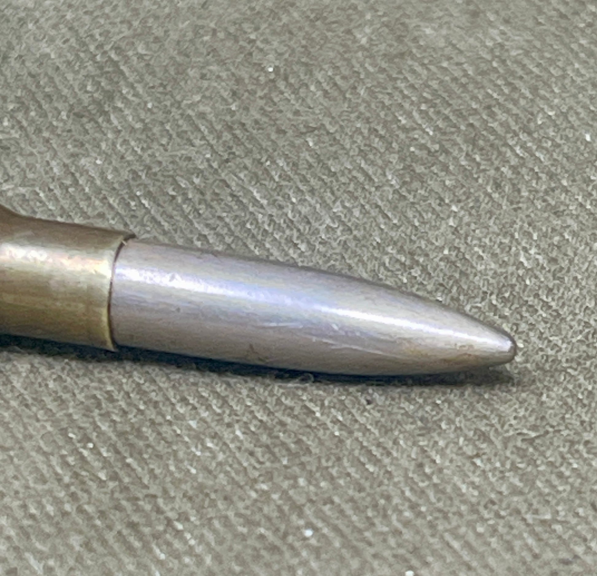 Metallic bullet on a textured surface