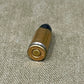Bullet casing on a textured beige surface