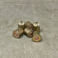 Set of six brass bullet casings on a gray surface
