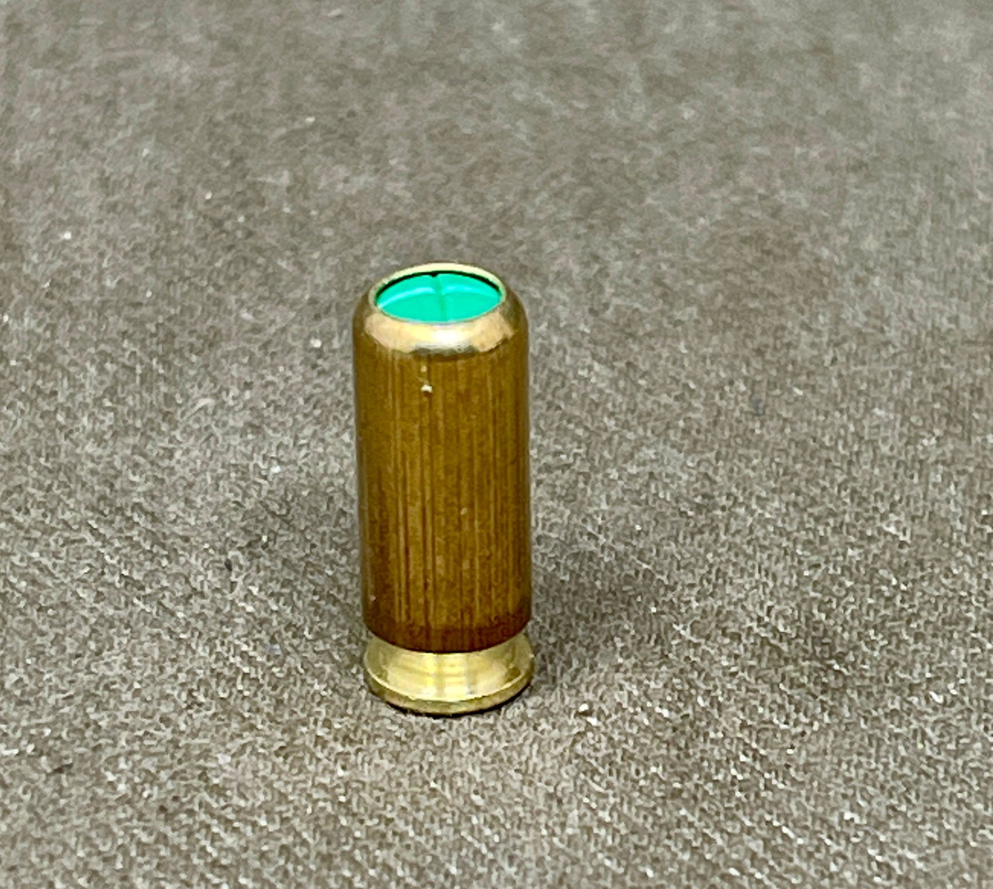 Wooden object with a green interior on a gray surface