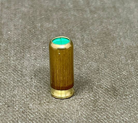 Wooden object with a green interior on a gray surface