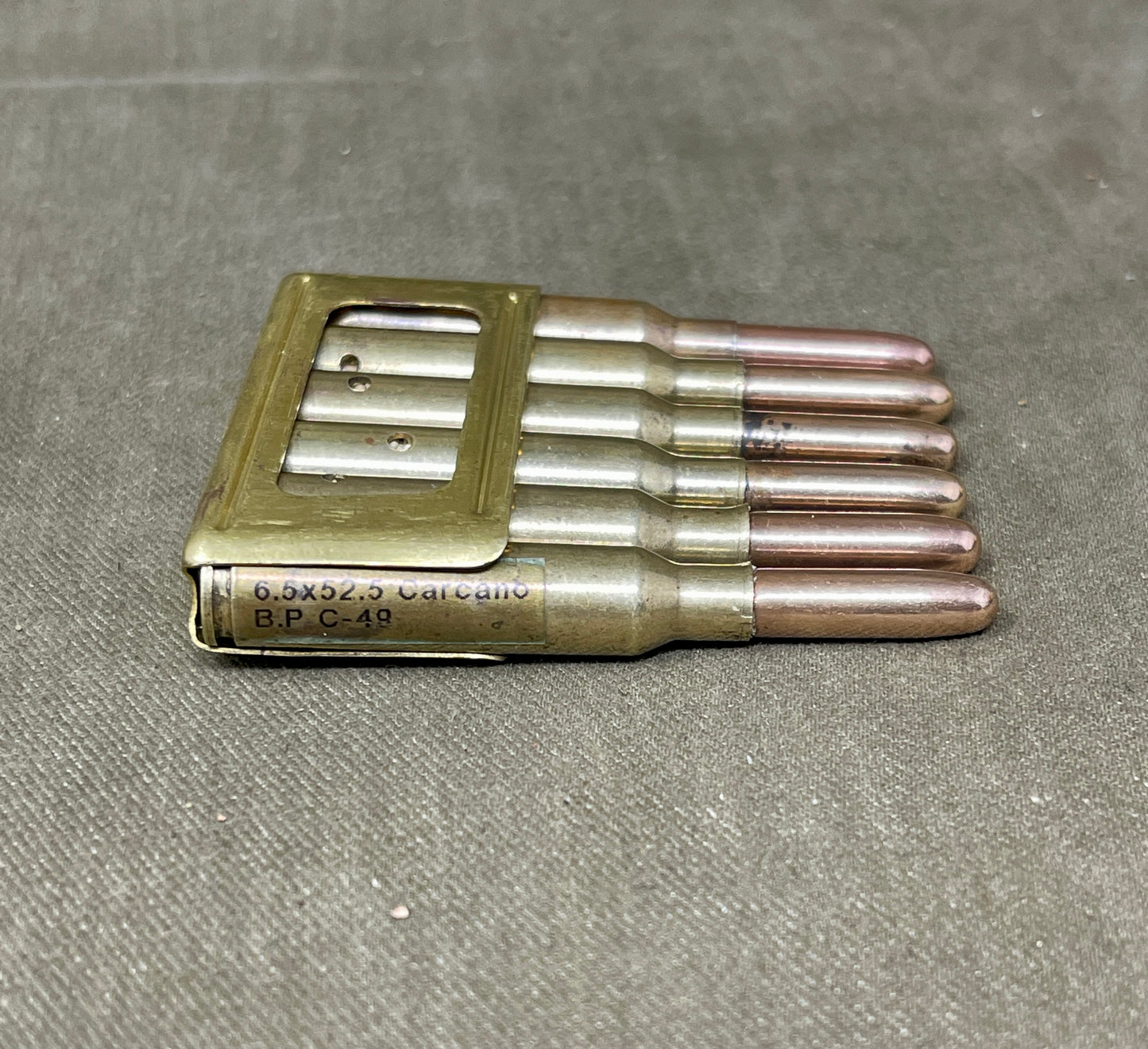 Set of metallic bullets on a textured gray surface
