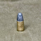 Bullet on a textured beige surface