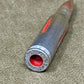 Close-up of a rifle bullet casing on a textured surface