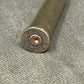 Close-up of a bullet casing on a textured gray surface