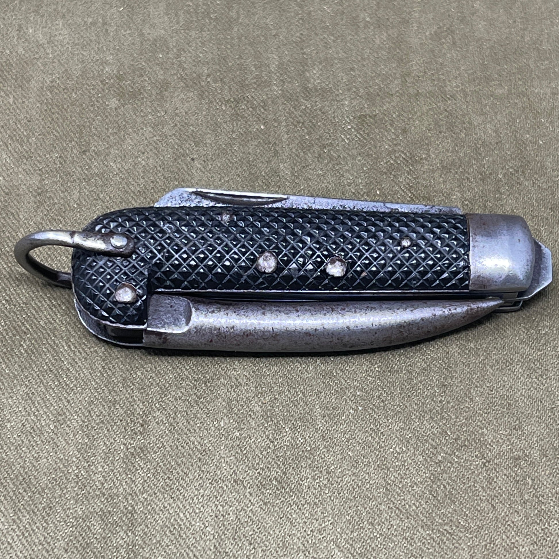 A nice example of a British 1942 Dated Pocket Jack Knife made by Clarke & Son of Sheffield  The blades are in good condition, the chequered Bakelite grip is intact and all the blades lock and close as they should. The steel can opener is in good condition