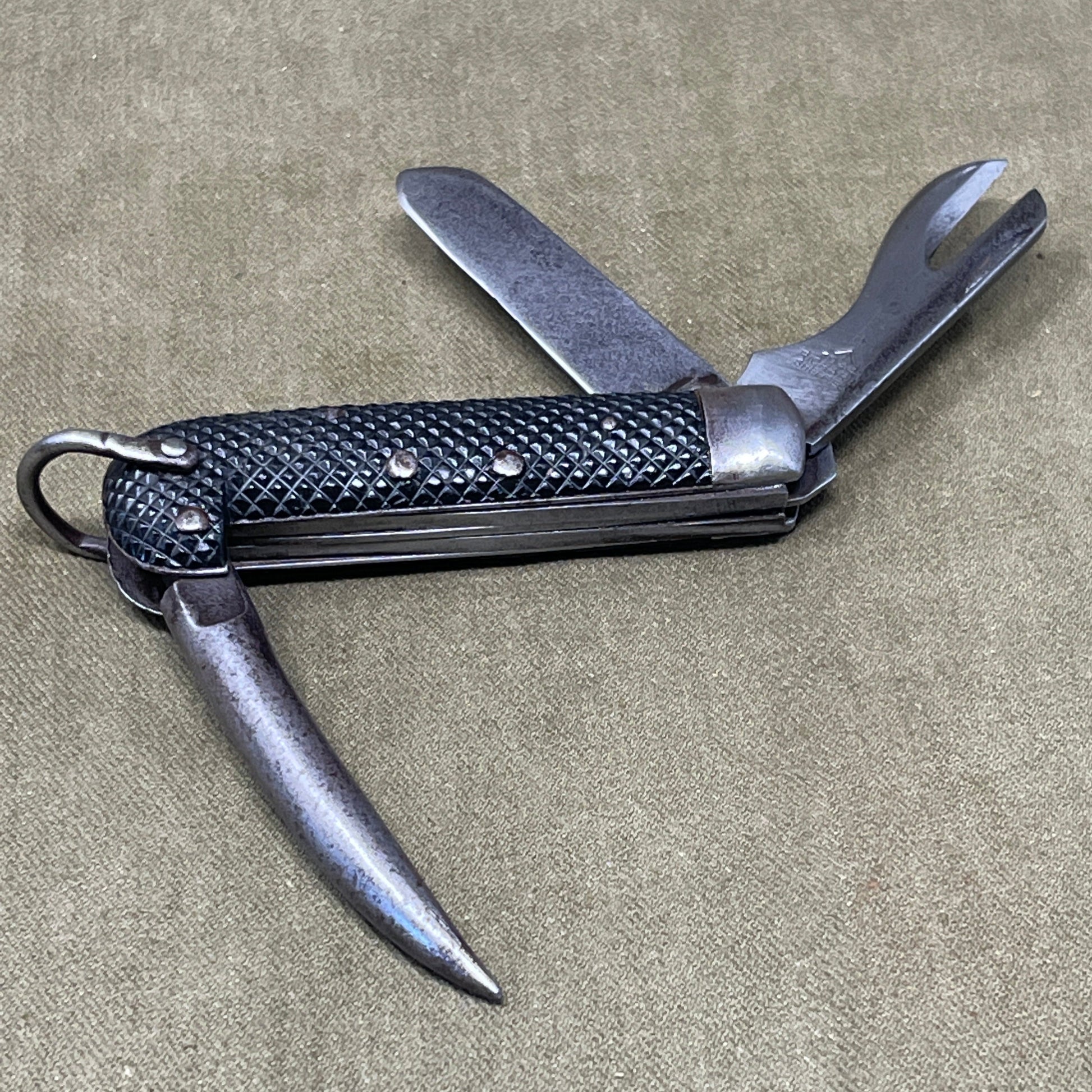 A nice example of a British 1942 Dated Pocket Jack Knife made by Clarke & Son of Sheffield  The blades are in good condition, the chequered Bakelite grip is intact and all the blades lock and close as they should. The steel can opener is in good condition