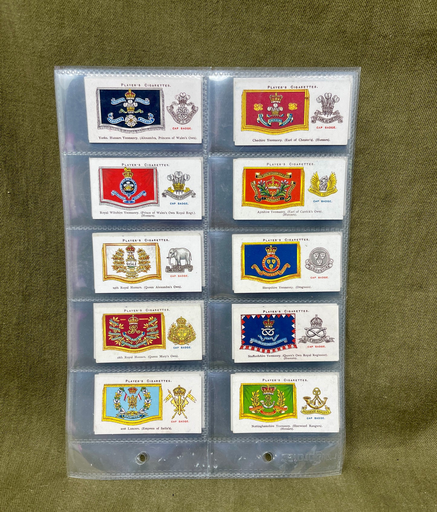 "Discover the John Player & Sons 'Drum Banners and Cap Badges' cigarette cards, featuring stunning illustrations and historical insights into British military insignia. A must-have collectible for military history enthusiasts."