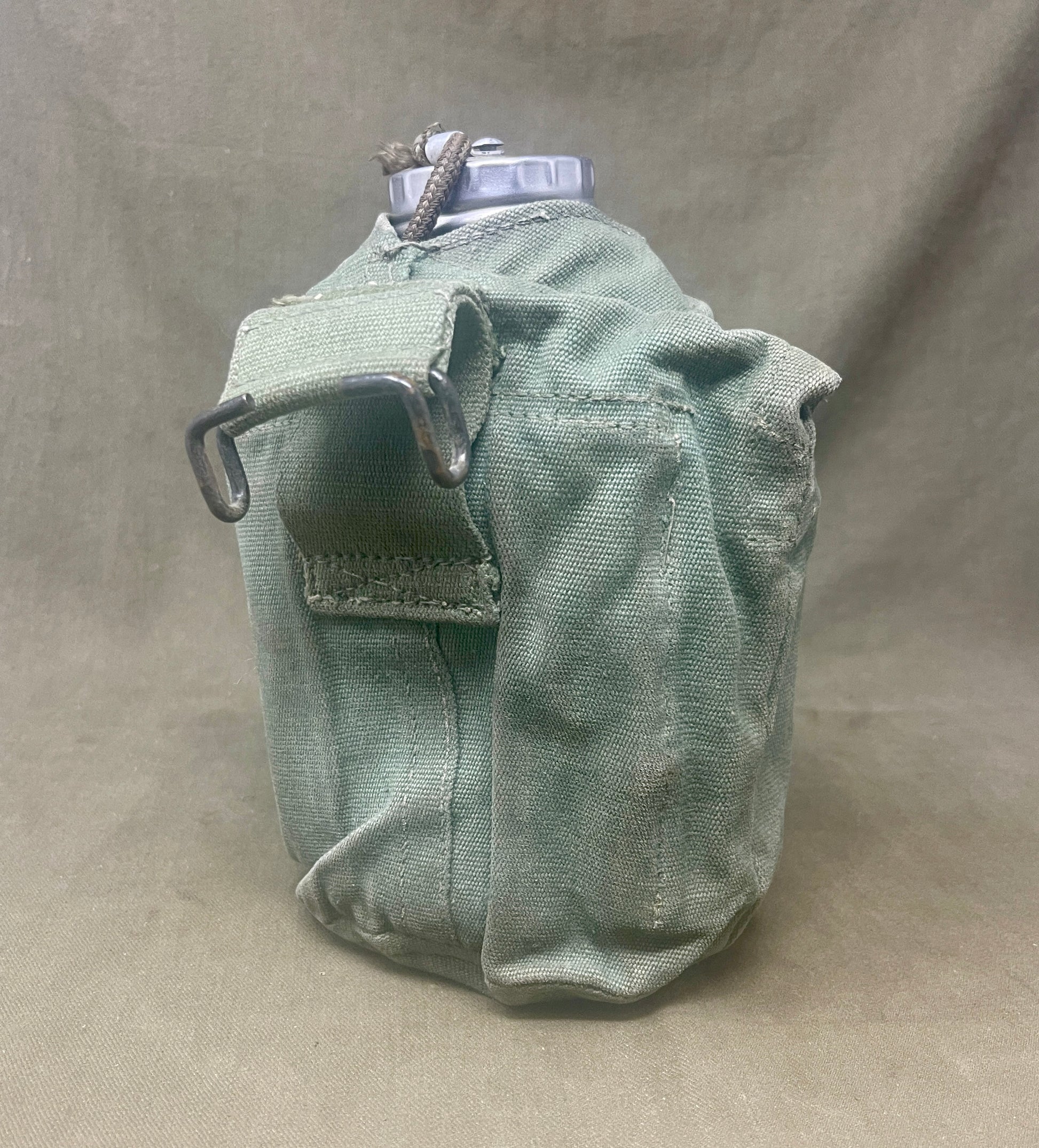 "Discover the British Army 1944 Pattern Water Bottle and Carrier, a durable and functional piece of WWII military equipment. A valuable collectible for enthusiasts of military history."