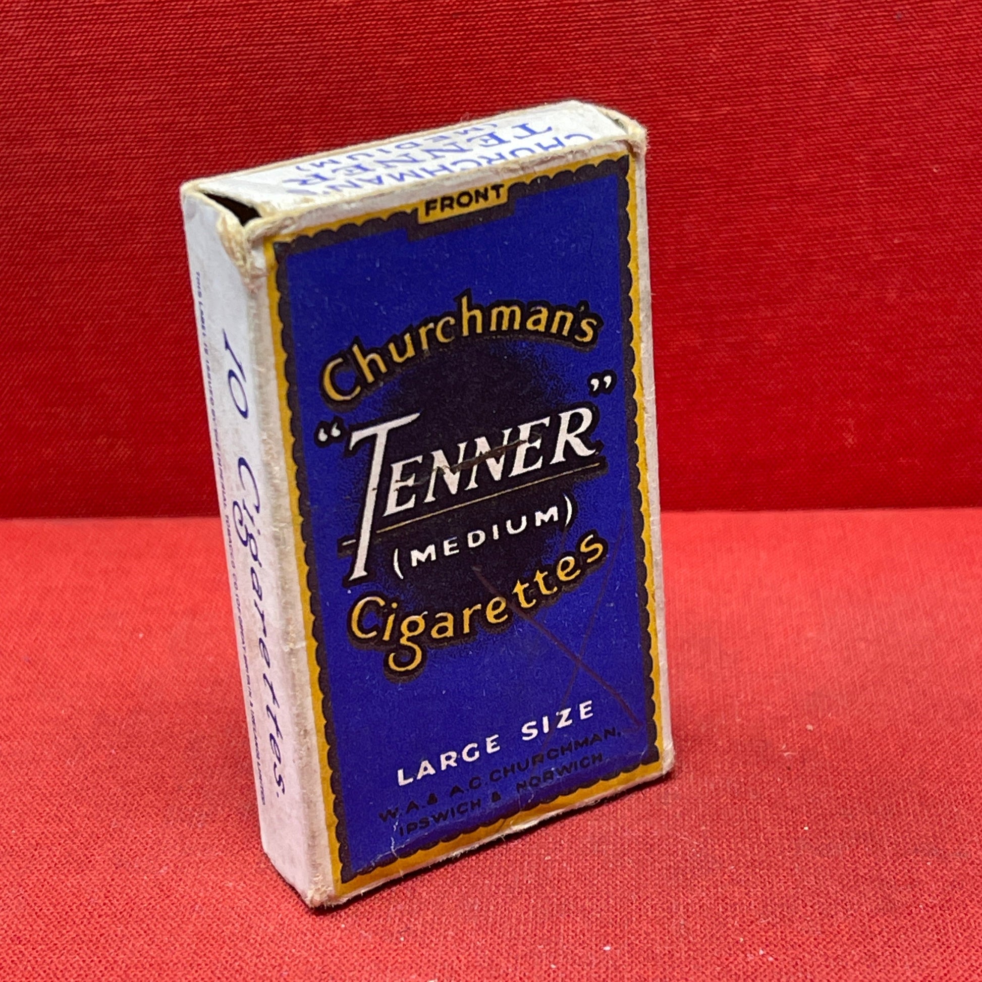 Cardboard cigarette packet consisting of a blue and black-printed sleeve and a cardboard drawer