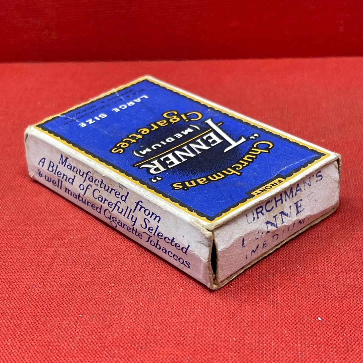 Cardboard cigarette packet consisting of a blue and black-printed sleeve and a cardboard drawer