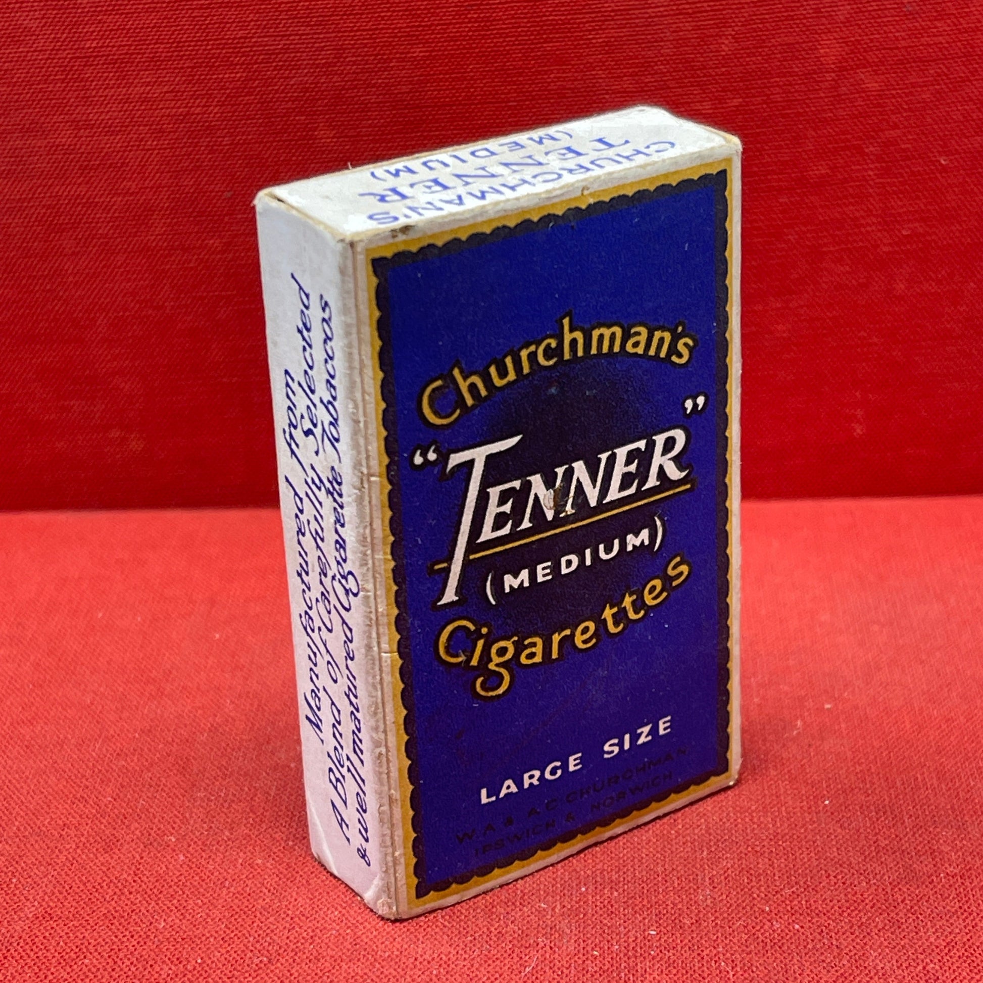 Cardboard cigarette packet consisting of a blue and black-printed sleeve and a cardboard drawer