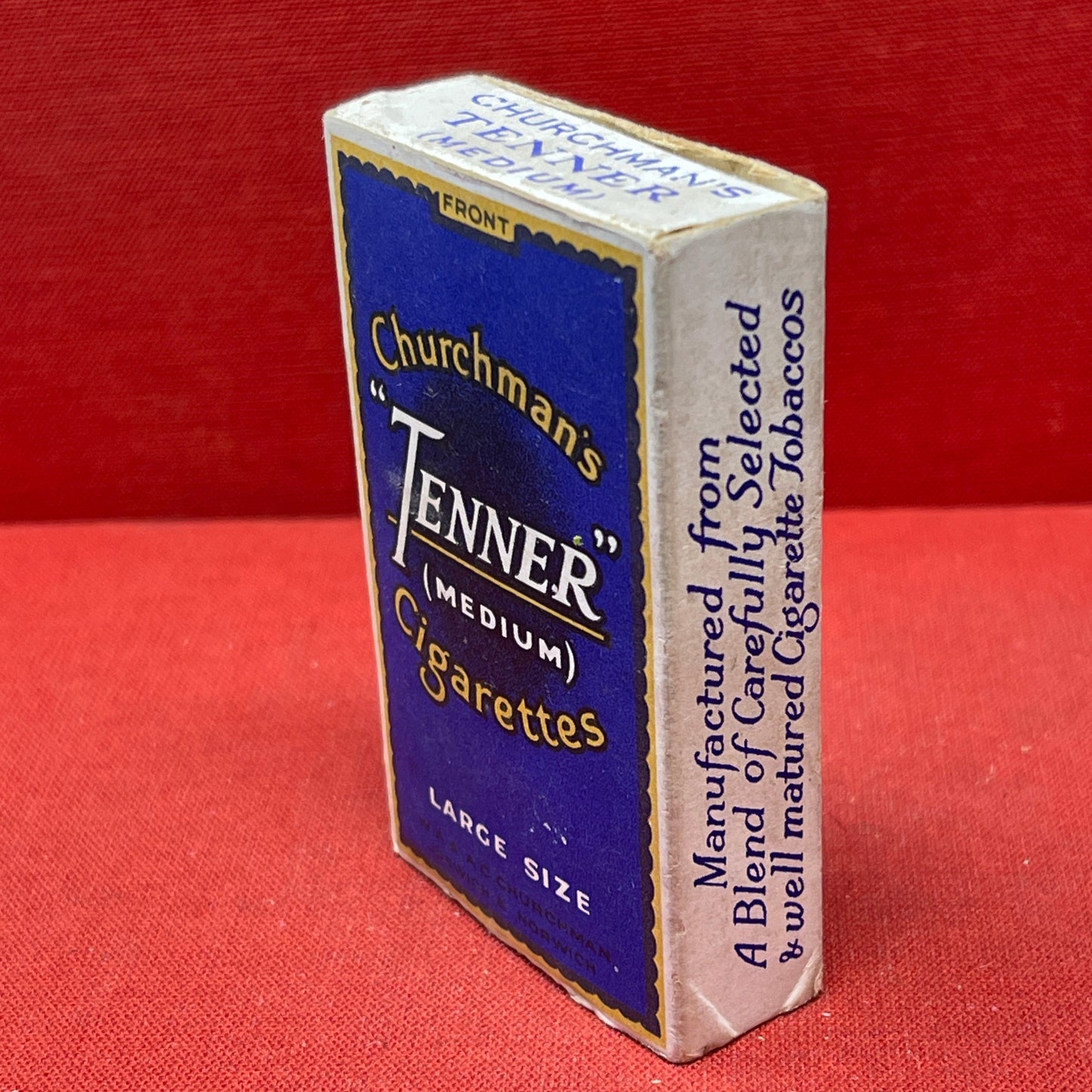 Cardboard cigarette packet consisting of a blue and black-printed sleeve and a cardboard drawer