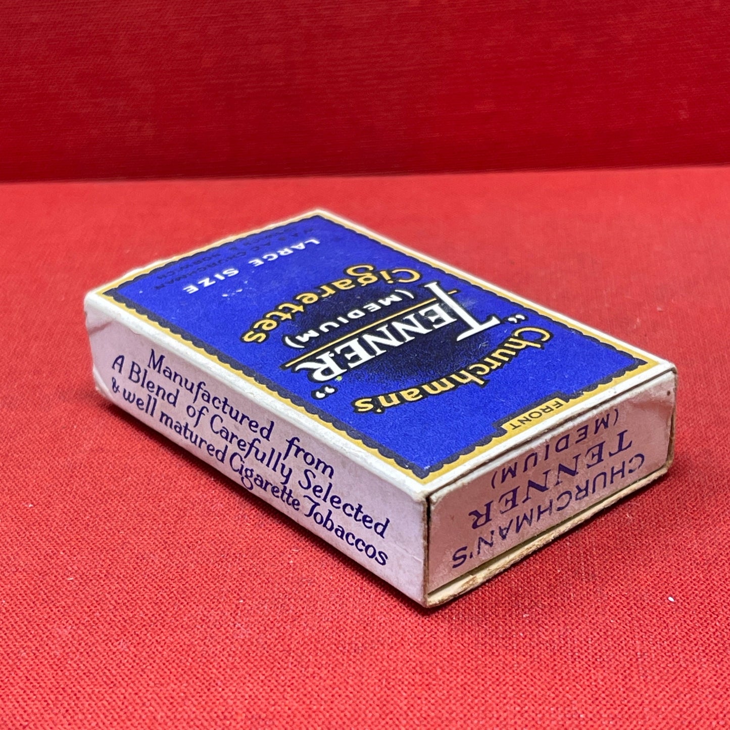 Cardboard cigarette packet consisting of a blue and black-printed sleeve and a cardboard drawer