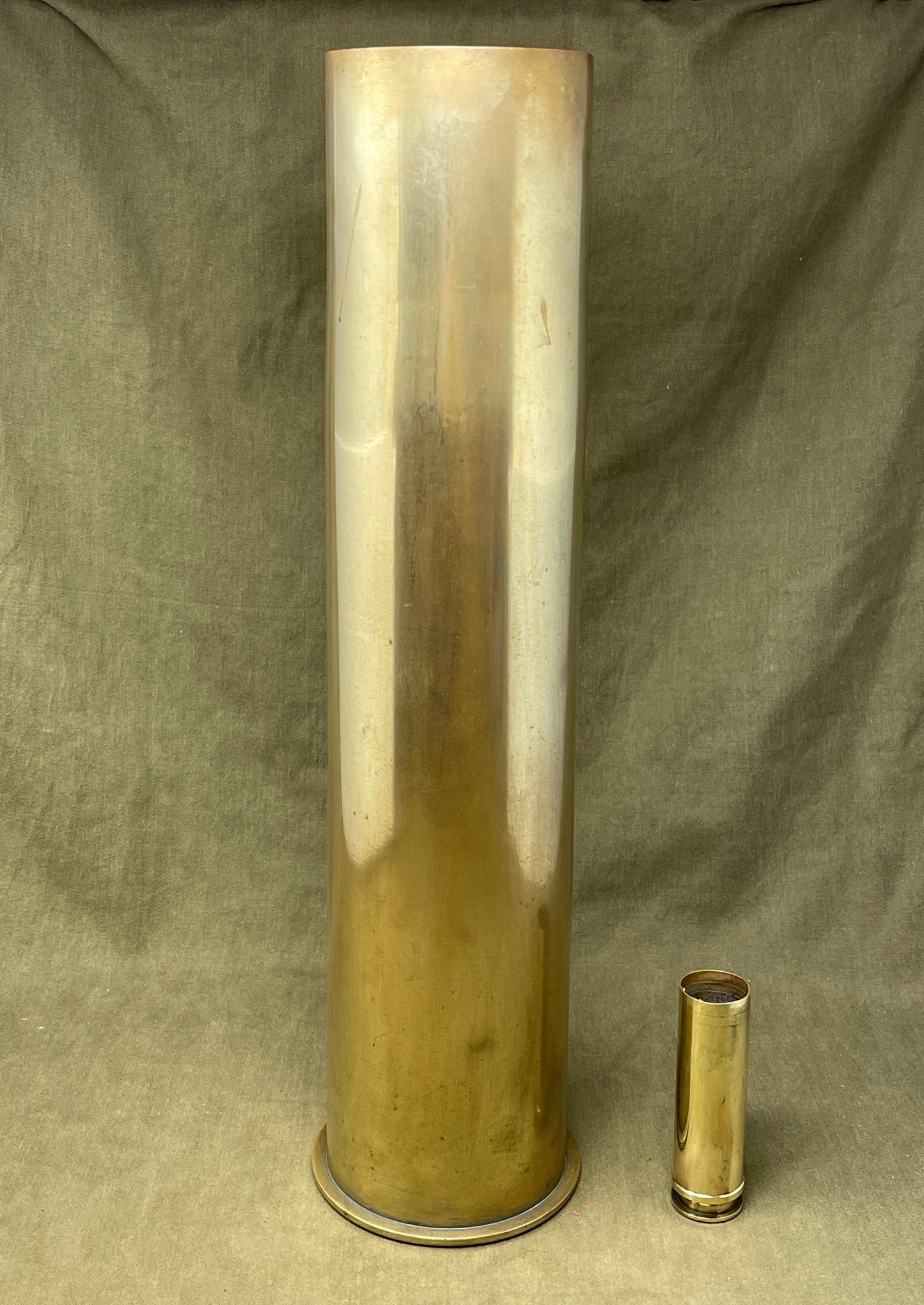 German brass 105mm artillery shell case was later used as an umbrella stand. The base is impressed 'Karth. Sp.255 446 MAI 1917 PATRONENFABRIK KARLSRUHE'. The striker is impressed 'FL 14B Sb'.