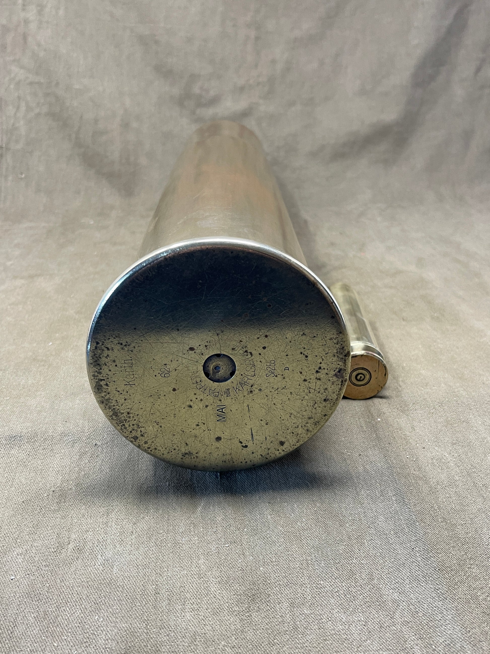 German brass 105mm artillery shell case was later used as an umbrella stand. The base is impressed 'Karth. Sp.255 446 MAI 1917 PATRONENFABRIK KARLSRUHE'. The striker is impressed 'FL 14B Sb'.