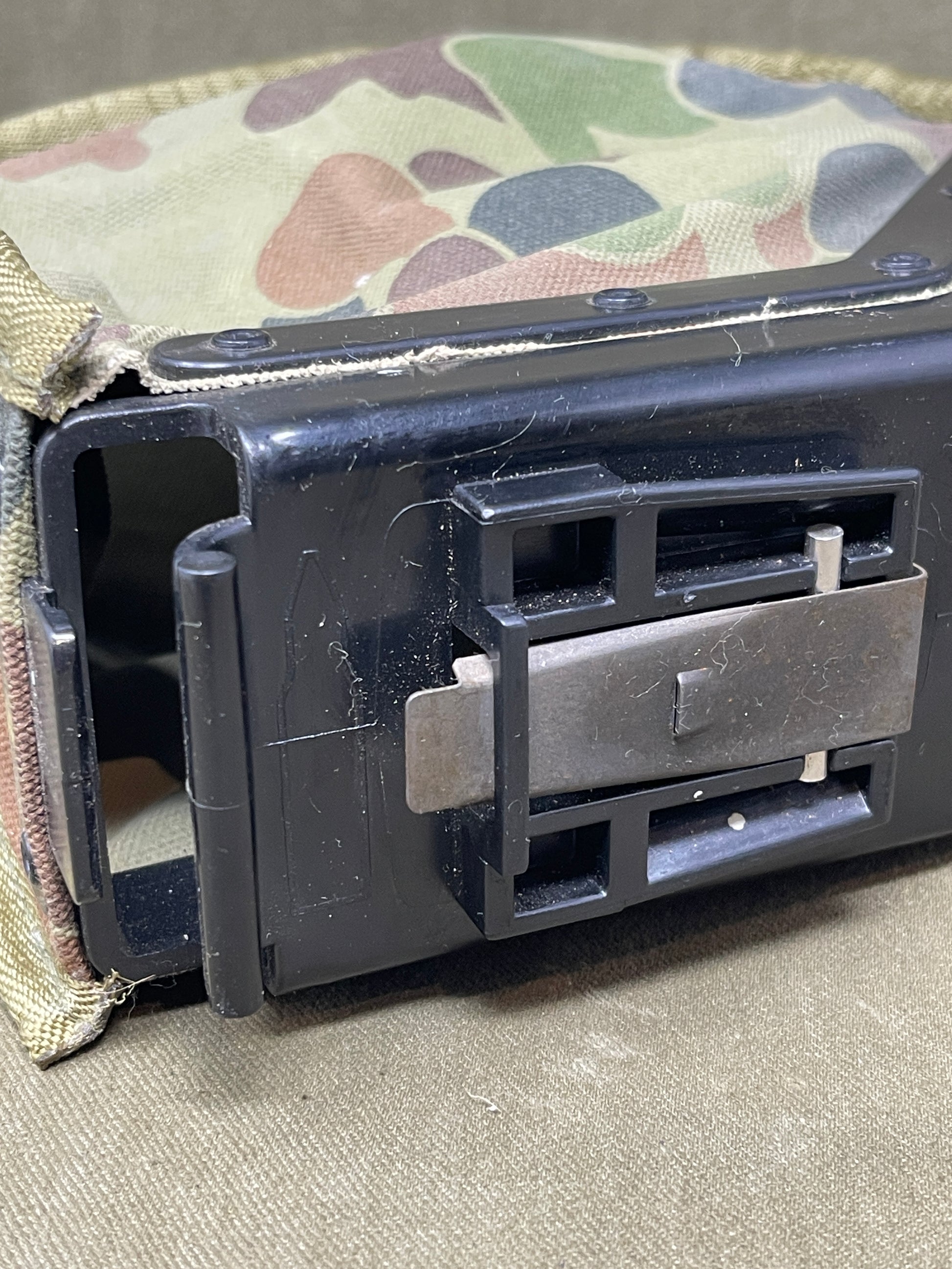 Australian Army LMG pouch, featuring the iconic Australian pattern camouflage. This pouch is designed for durability and functionality, constructed from rugged, heavy-duty materials capable of withstanding harsh field conditions. Its distinctive camouflage pattern ensures effective concealment across a variety of Australian terrains, including dense bushland and arid environments.