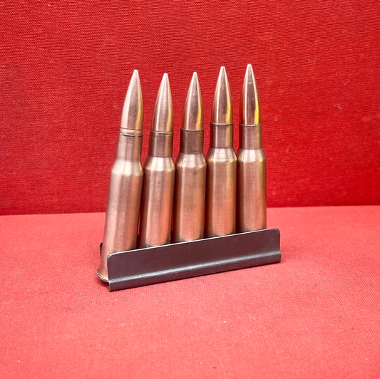 "Discover 5 authentic 7.62x54mm Russian inert cartridges on a classic stripper clip. Perfect for collectors and enthusiasts, these safe, deactivated rounds showcase military history."