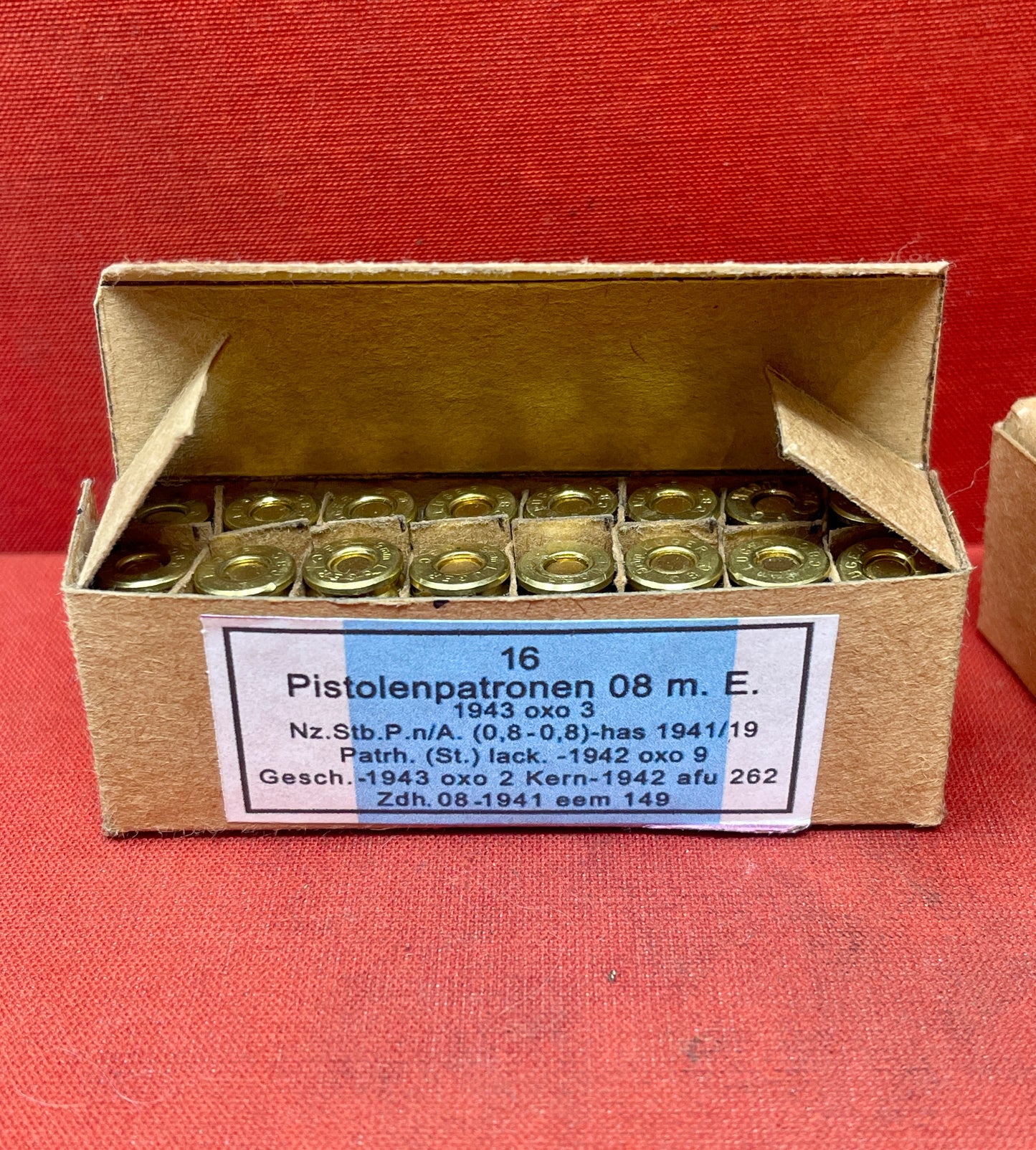 Explore this WWII German Small Arms Ammunition Set, featuring 16 inert 9mm Luger rounds with inert primers and 15 inert 7.92x57mm K98 rounds on three stripper clips. Packaged in handmade replica boxes, this bespoke kit is perfect for collectors and enthusiasts.