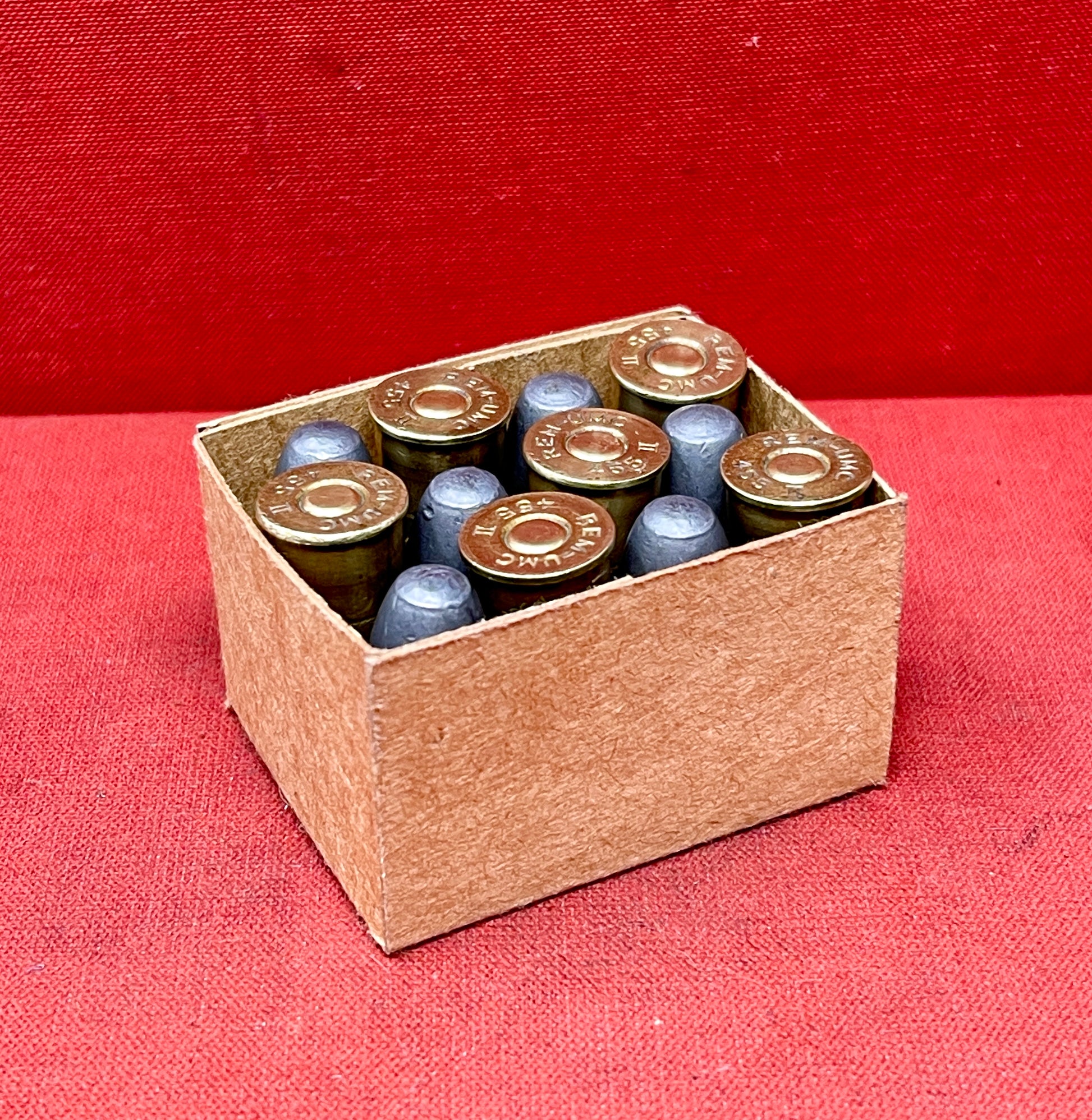 Authentic 12-round reproduction box of British .455 inert/display revolver cartridges. Perfect for collectors, reenactors, and historical displays. Safe & non-functional.