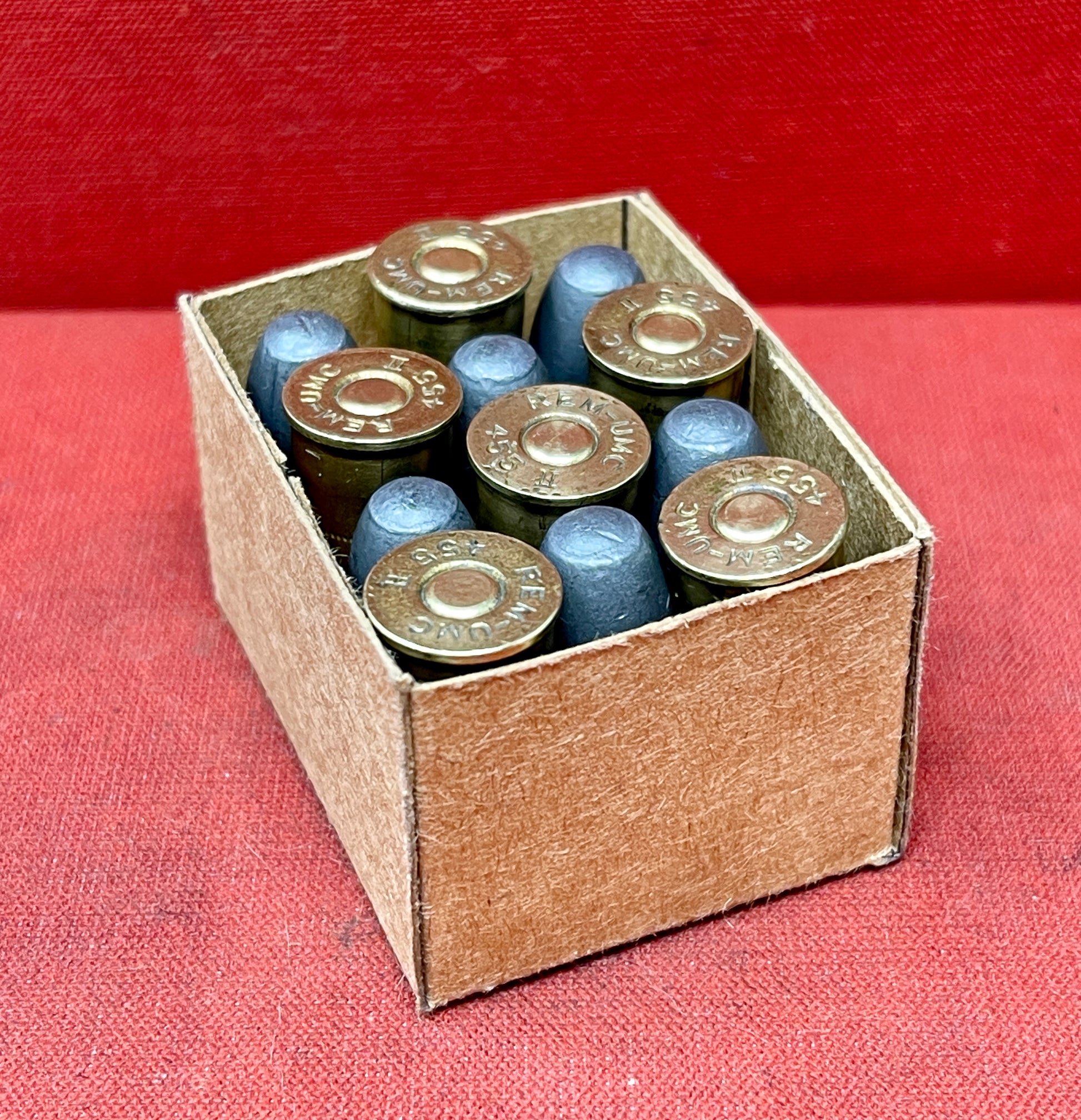 Authentic 12-round reproduction box of British .455 inert/display revolver cartridges. Perfect for collectors, reenactors, and historical displays. Safe & non-functional.