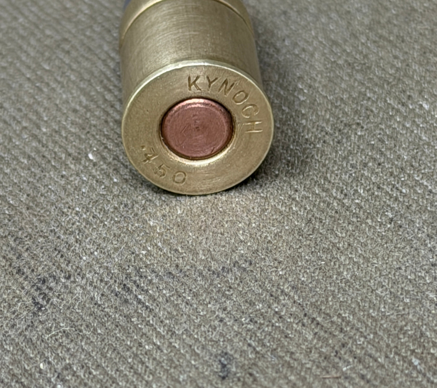An original .450 calibre Kynoch inert brass cartridge