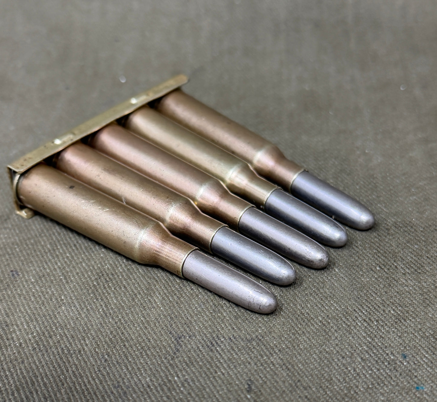 Original Japanese Type 38 Arisaka 6.5mm Inert Rounds on Charger Clip – WW2 / Pre-WW2