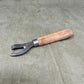 Authentic WWII German Wehrmacht can opener with original wood handle. A rare and practical piece of wartime field equipment for collectors and historians.


