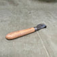Authentic WWII German Wehrmacht can opener with original wood handle. A rare and practical piece of wartime field equipment for collectors and historians.

