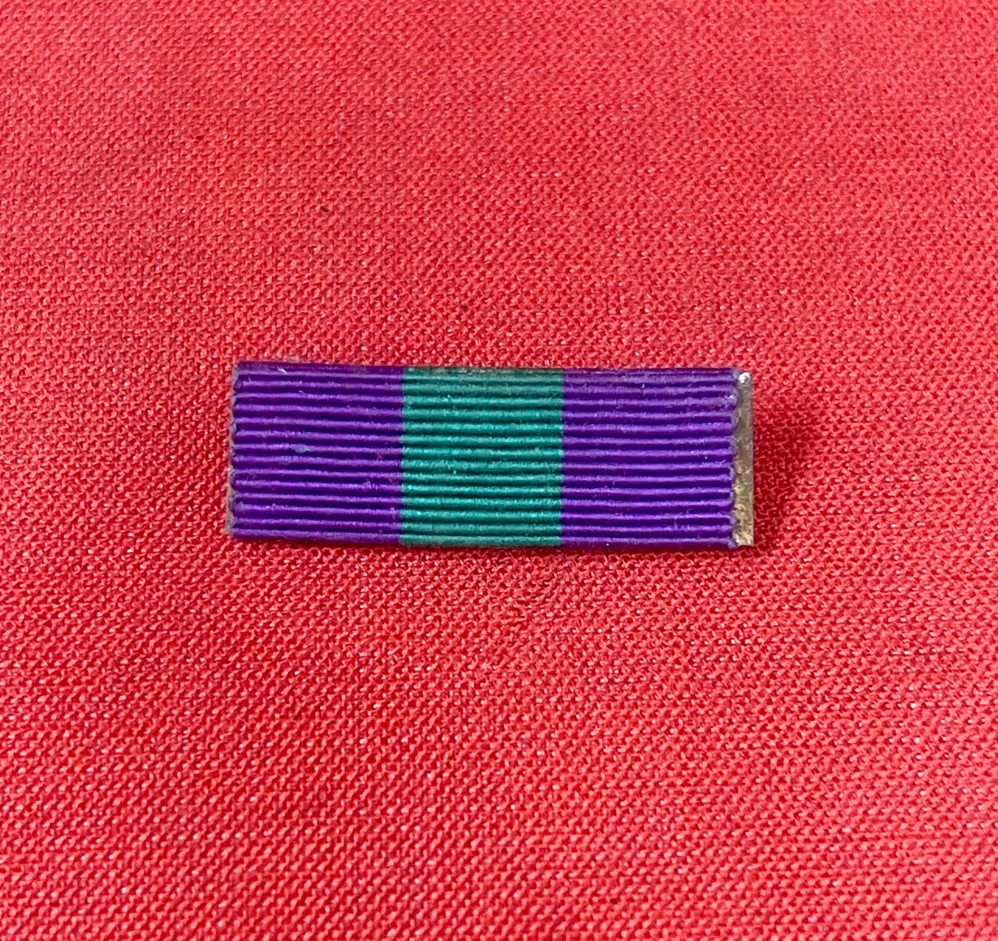 The King George VI General Service Medal (GSM) 1918-1962 ribbon is purple with a central green stripe