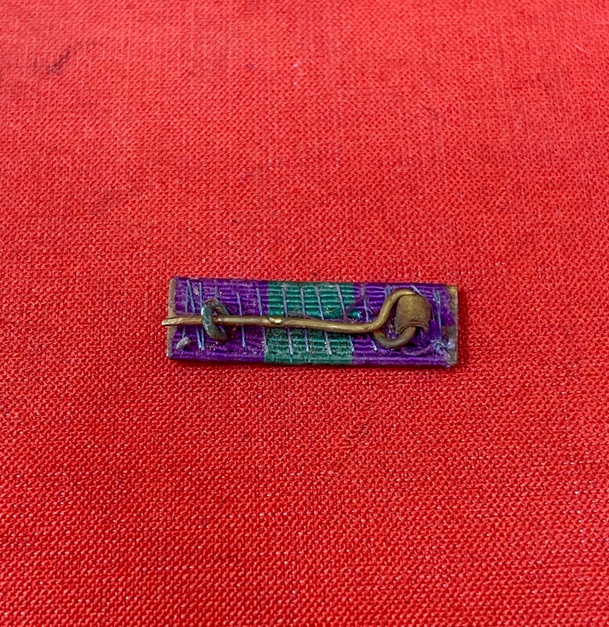 The King George VI General Service Medal (GSM) 1918-1962 ribbon is purple with a central green stripe
