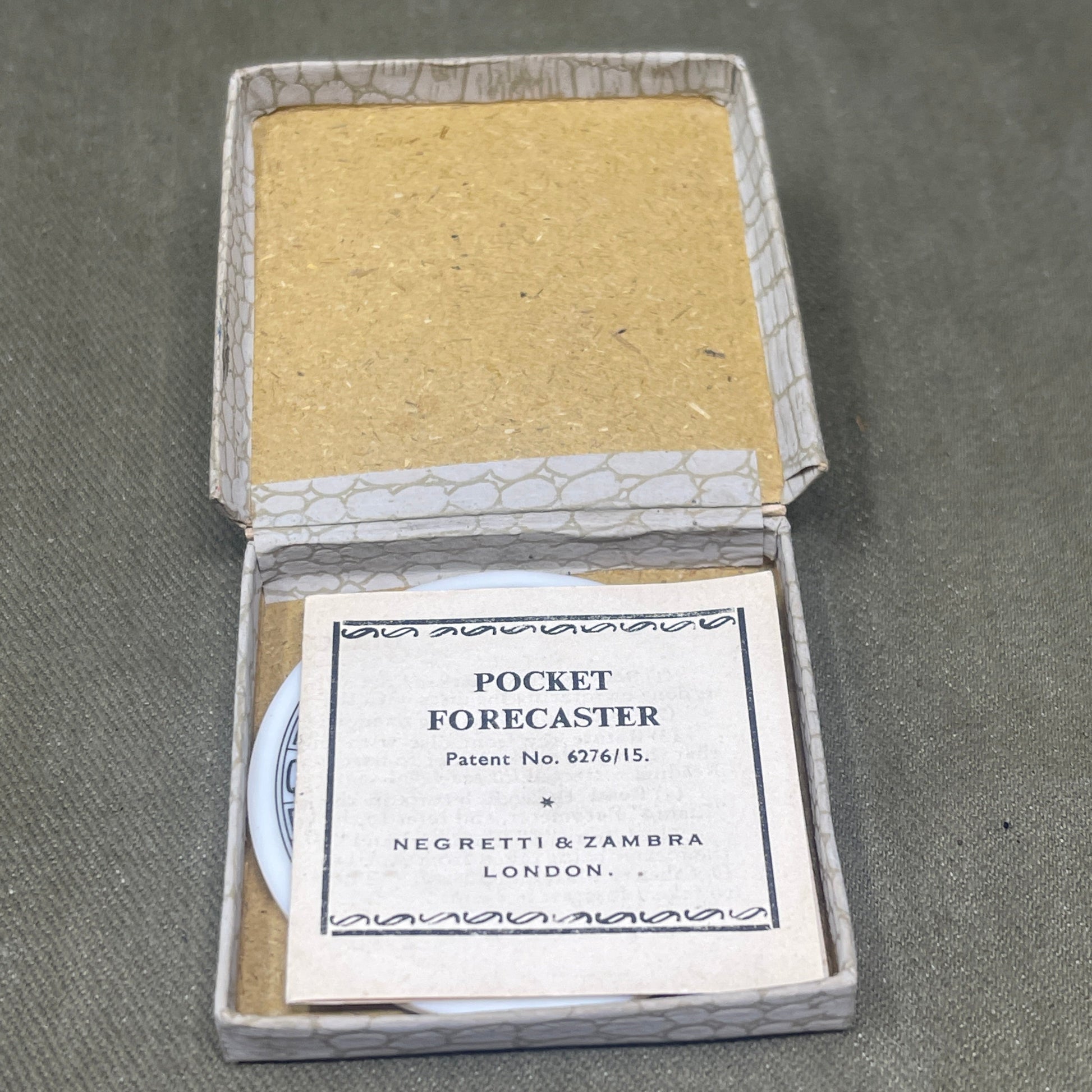 Small open box with a yellow square and a label on a gray background