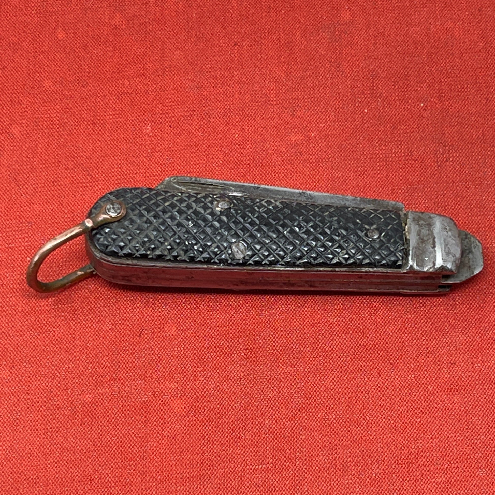 A nice example of a British Jack Knife, dated 1940  The blades are in good condition, the chequered Bakelite grip is intact and all the blades lock and close as they should. The steel can opener is in good condition