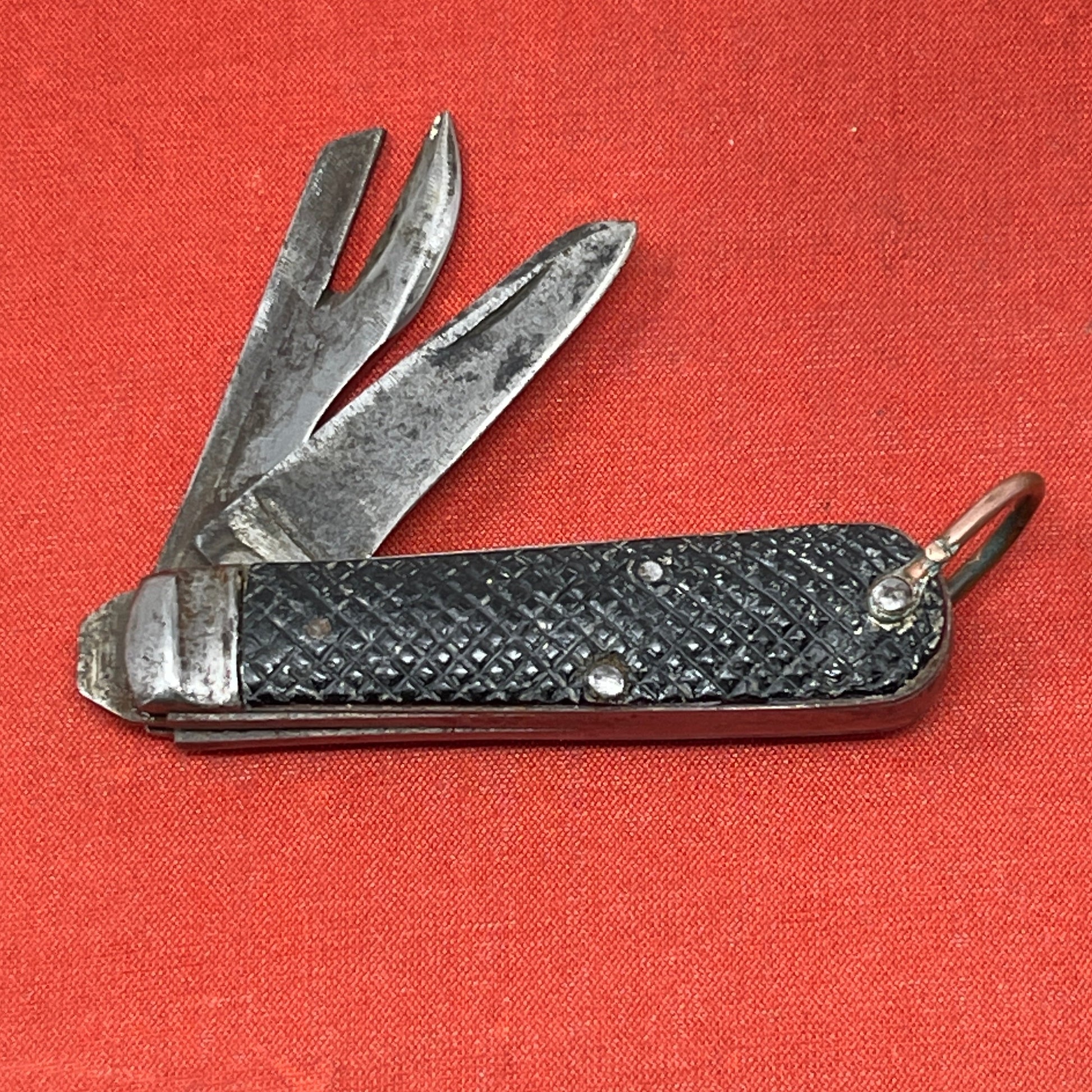 A nice example of a British Jack Knife, dated 1940  The blades are in good condition, the chequered Bakelite grip is intact and all the blades lock and close as they should. The steel can opener is in good condition