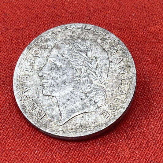 5 francs coin, France, 1946. Aluminium; 31mm diameter, 2mm deep. obverse: RF 5 FRANCS 1946. wreath. reverse: REPVBLIQVE FRANCAISE, head to l., signed at base, A. LAVRILLIER