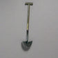 Shovel on a brick and concrete surface