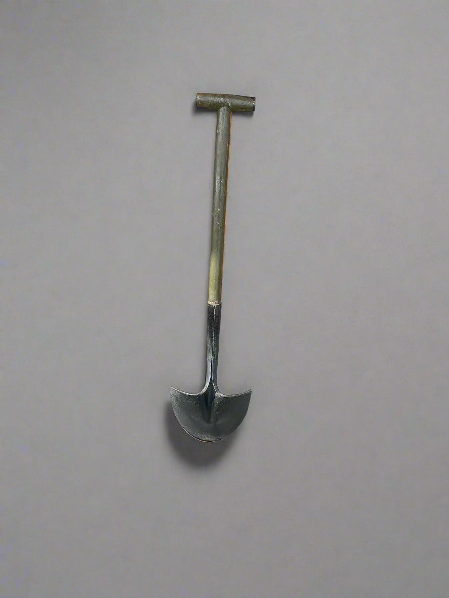 Shovel on a brick and concrete surface