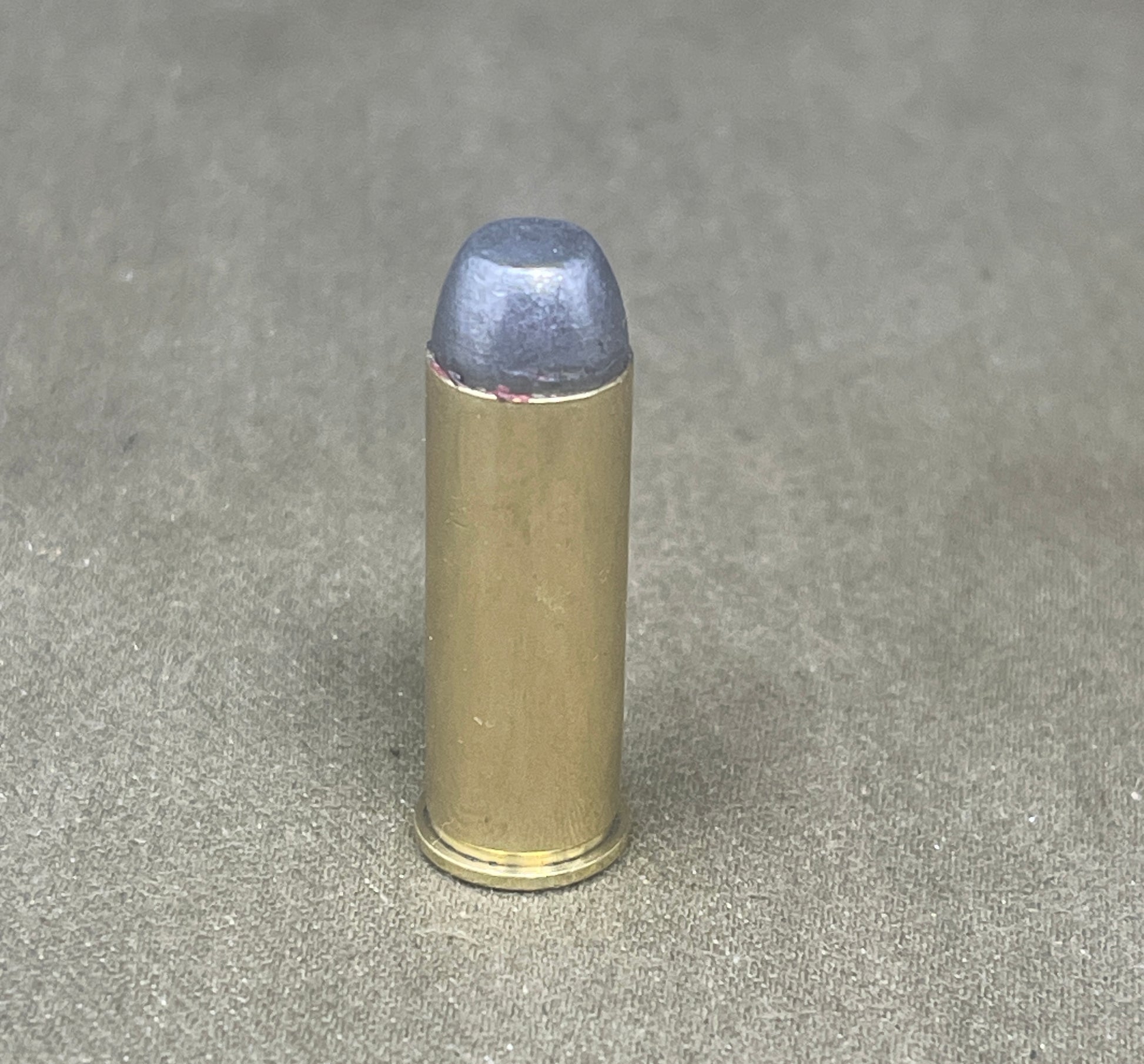 Bullet casing on a gray concrete surface