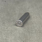 Metallic cylindrical object with 'Winchester' branding on a concrete surface