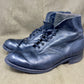 Pair of blue leather boots on a beige background