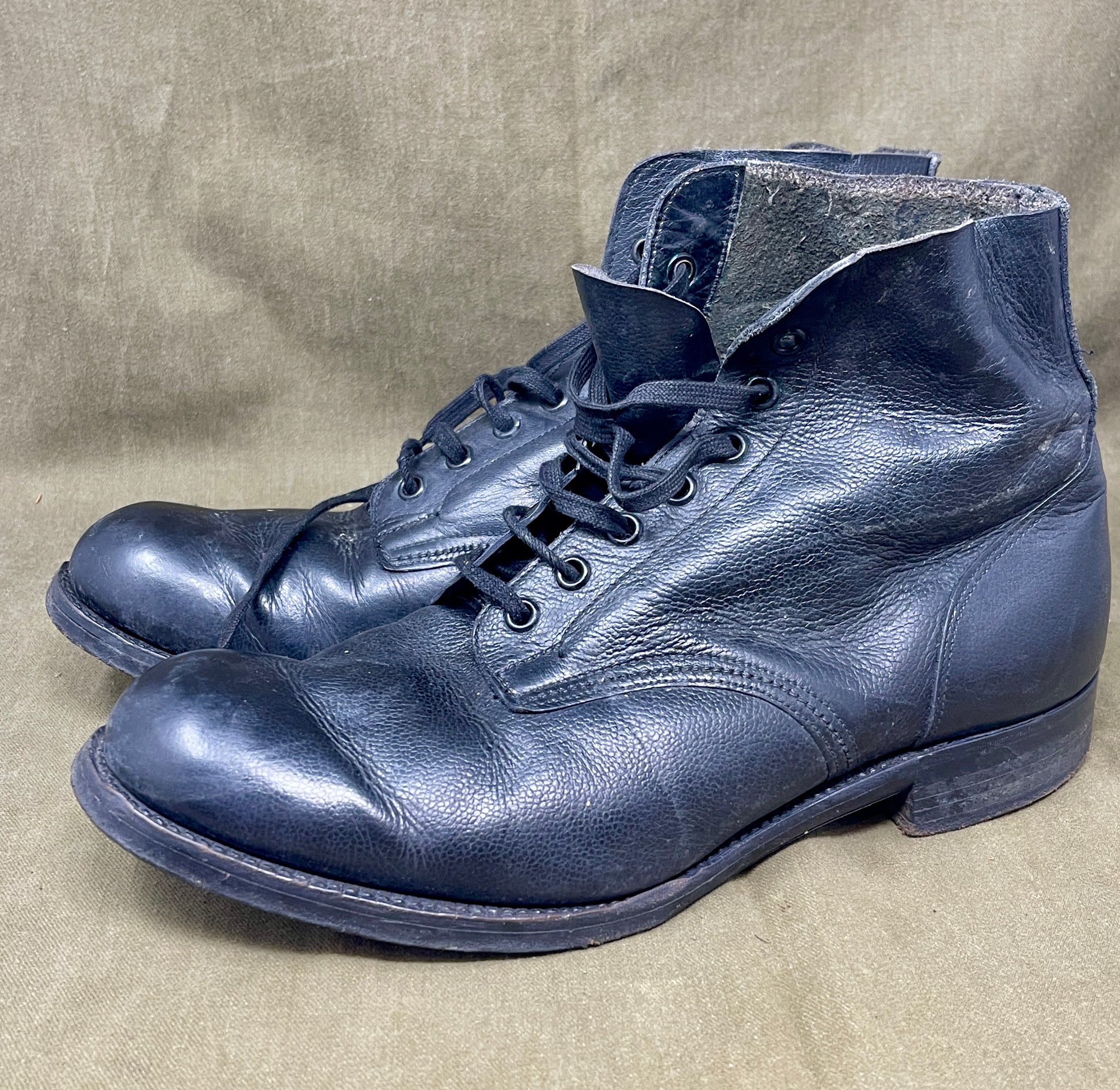 Pair of blue leather boots on a beige background