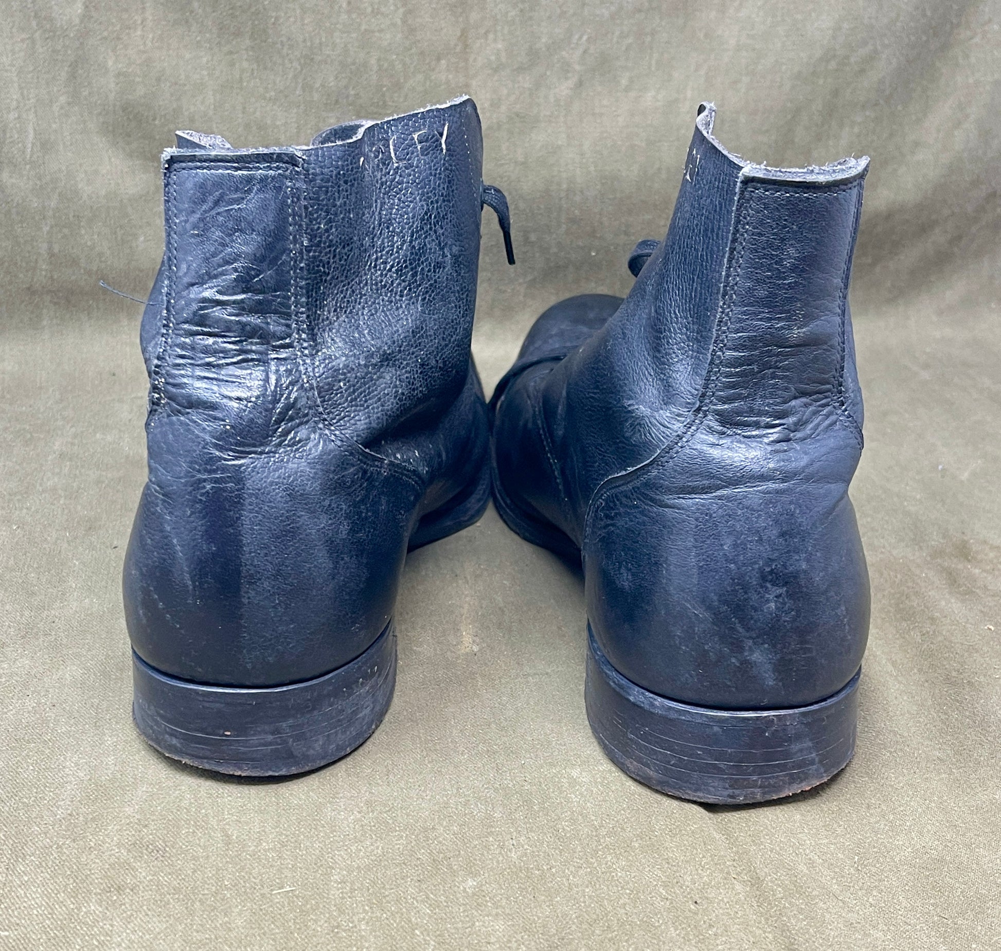 Pair of blue leather boots on a gray background