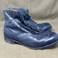 Pair of worn blue leather boots on a beige background