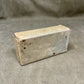 Rectangular concrete block on a gray background