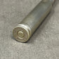 Close-up of a metal cylindrical object with 'Norma' branding on a gray surface